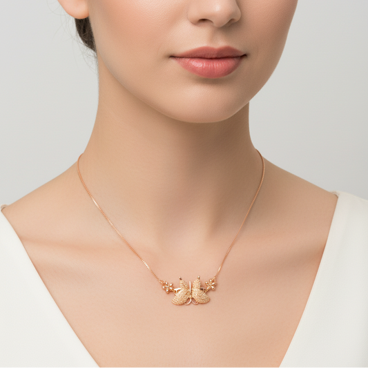 Rose gold butterfly necklace on a model against a neutral background