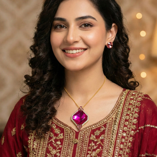 Woman wearing a red and gold traditional outfit with jewelry against a warm-toned background.