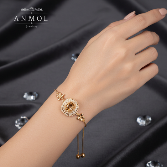 Gold bracelet on a hand with ANMOL Jewelry logo