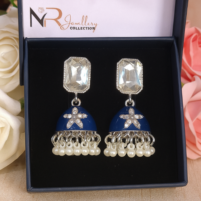 Blue and silver earrings with star designs on a black card with 'NR Jewellery Collection' branding, surrounded by flowers.