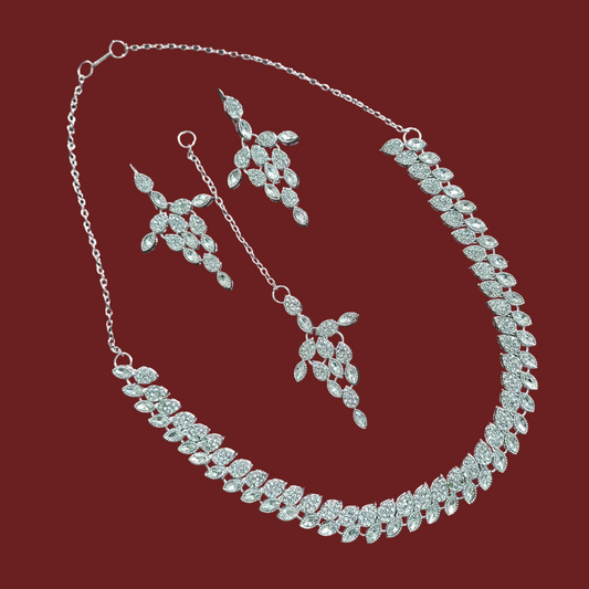 Silver necklace and earrings set on a red background