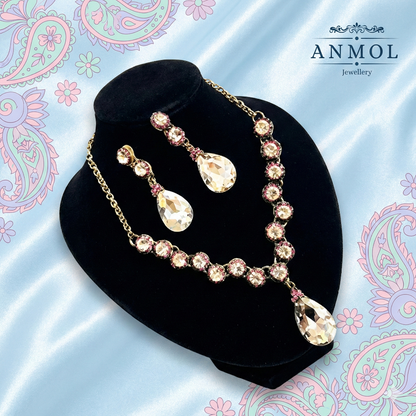 Jewelry set with necklace and earrings on a black stand against a decorative background with 'ANMOL Jewellery' branding.