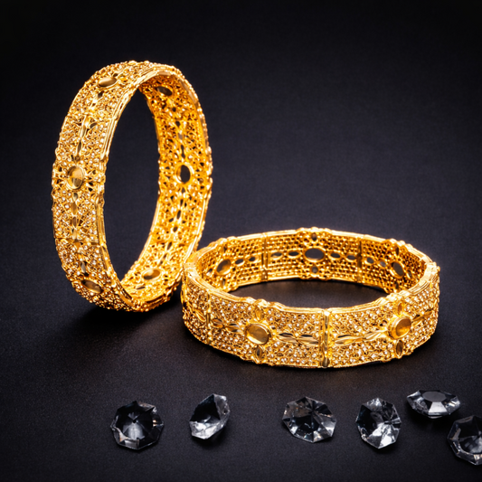 Two gold bracelets with intricate designs on a black background